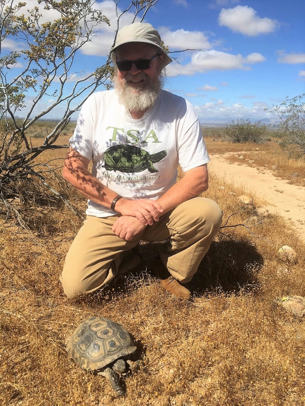 George L. Heinrich with species #23: Mojave desert tortoise ( Gopherus agassizii ) at the Desert Tortoise Natural Area (California City, California). Photograph by Michael Bargeron.