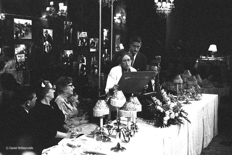 Tracy Mygatt, with WRL Chair Roy Finch behind her, presenting the award plaque to honoree Jeannette Rankin, NYC 1958.