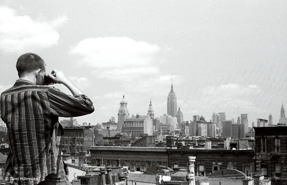 Ben Jaxon and the city from David's apartment building roof at 92 E. First Street, July 1956. (56-22)