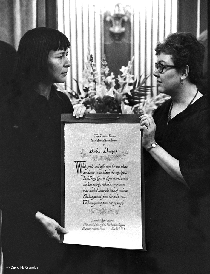 Barbara Deming (left) receives the War Resisters League Peace Award in 1967. Artist Janet Toy presented the award.