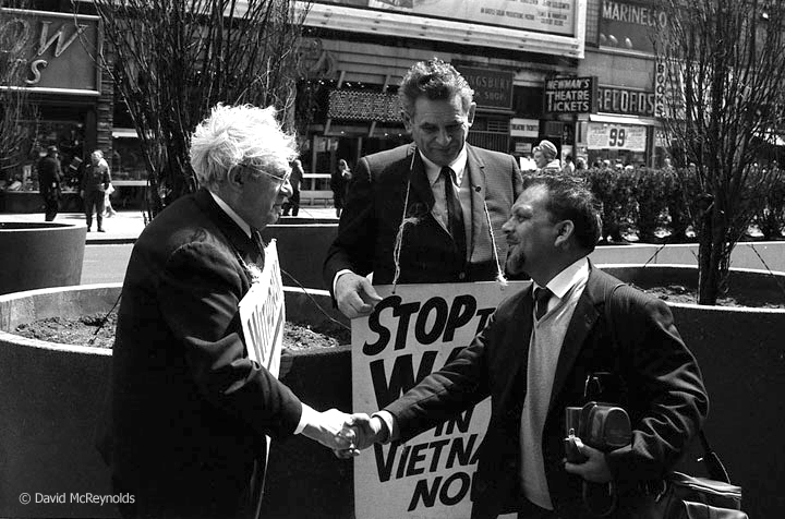  War Resisters’ International (WRI) Secretary Devi Prasad (right) meets Otto Nathan at the weekly Times Square vigil to end the war in Vietnam. War Resisters League Chairperson Eddie Gottlieb is in the center. The vigil began in October 1964 and was 