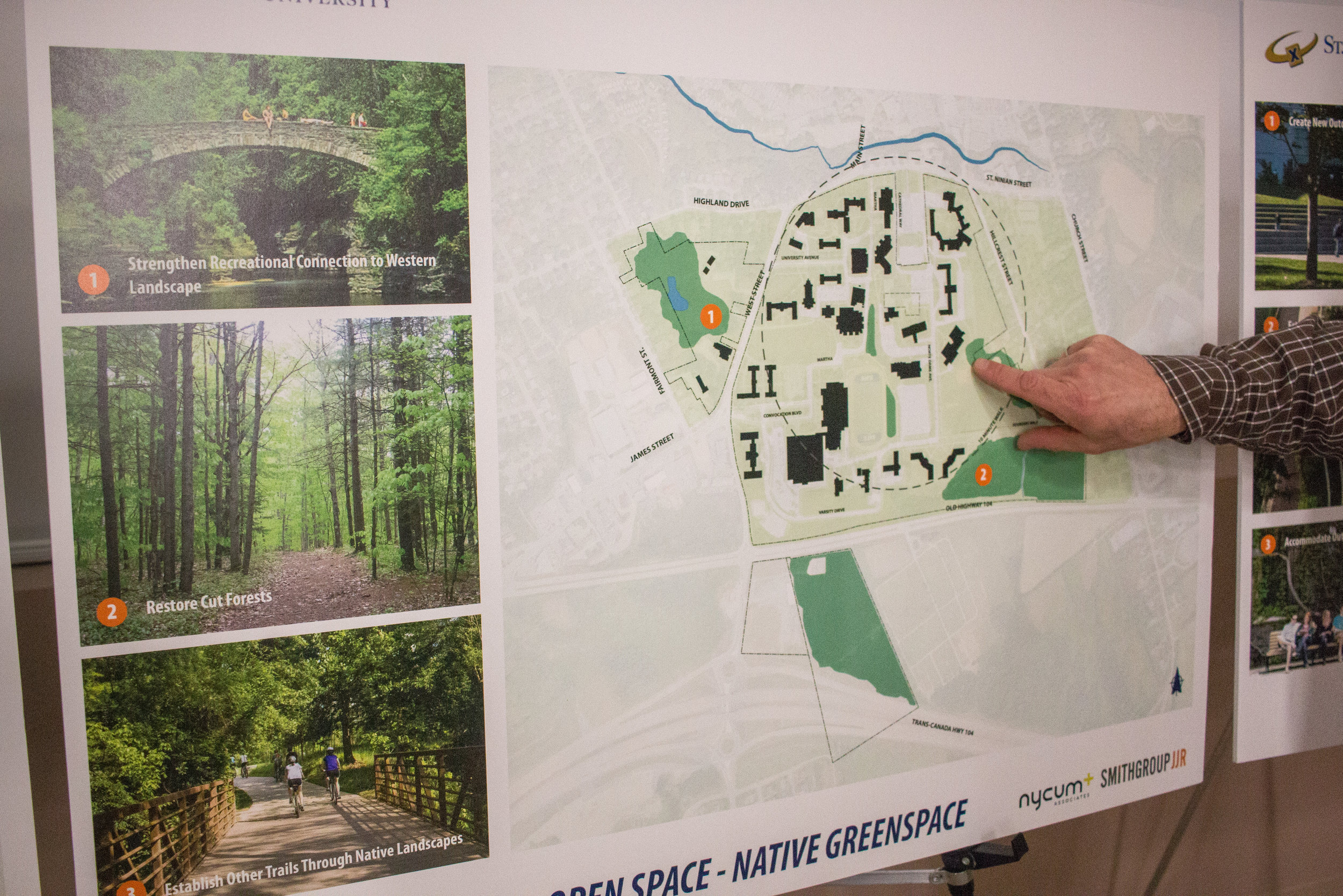  An attendee points out issues with the lack of natural green space on campus. 