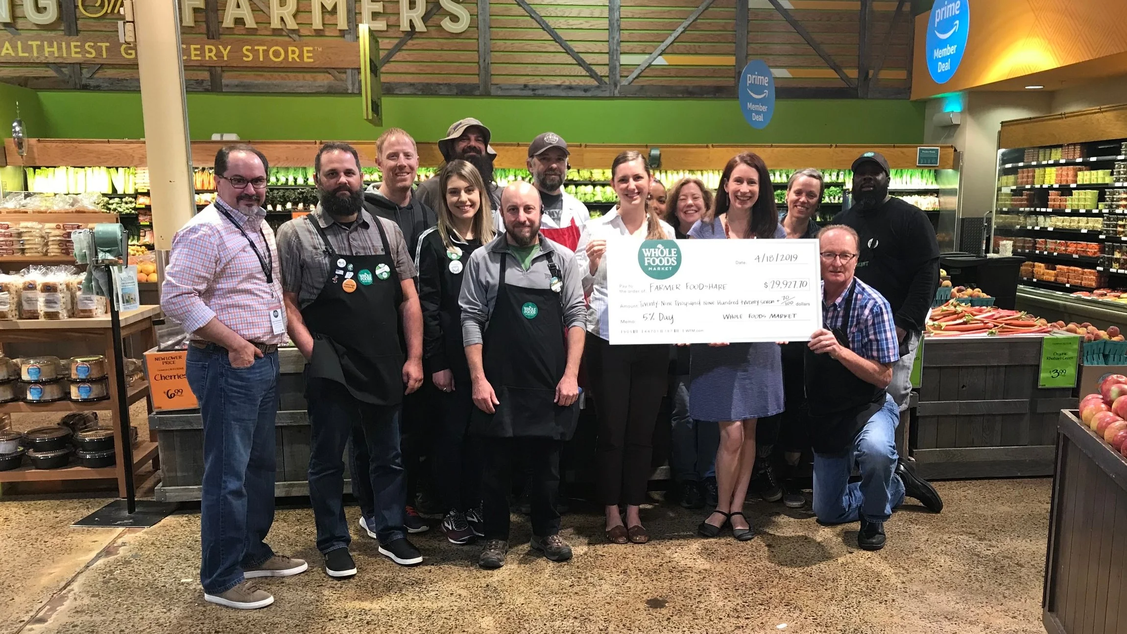 Farmer Foodshare’s Executive Director Gini Bell (left, behind check) and Director of Development and Communications Kate Rugani (right, behind check) were thrilled to accept a HUGE check (pun intended!) at the Chapel Hill Whole Foods Market.