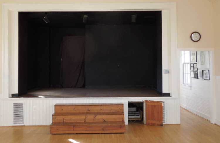 Steps to the stage can be moved or put on the stage. There are additional tables under the stage.
