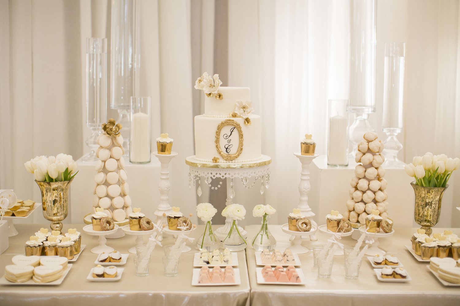White and gold wedding cake dessert table