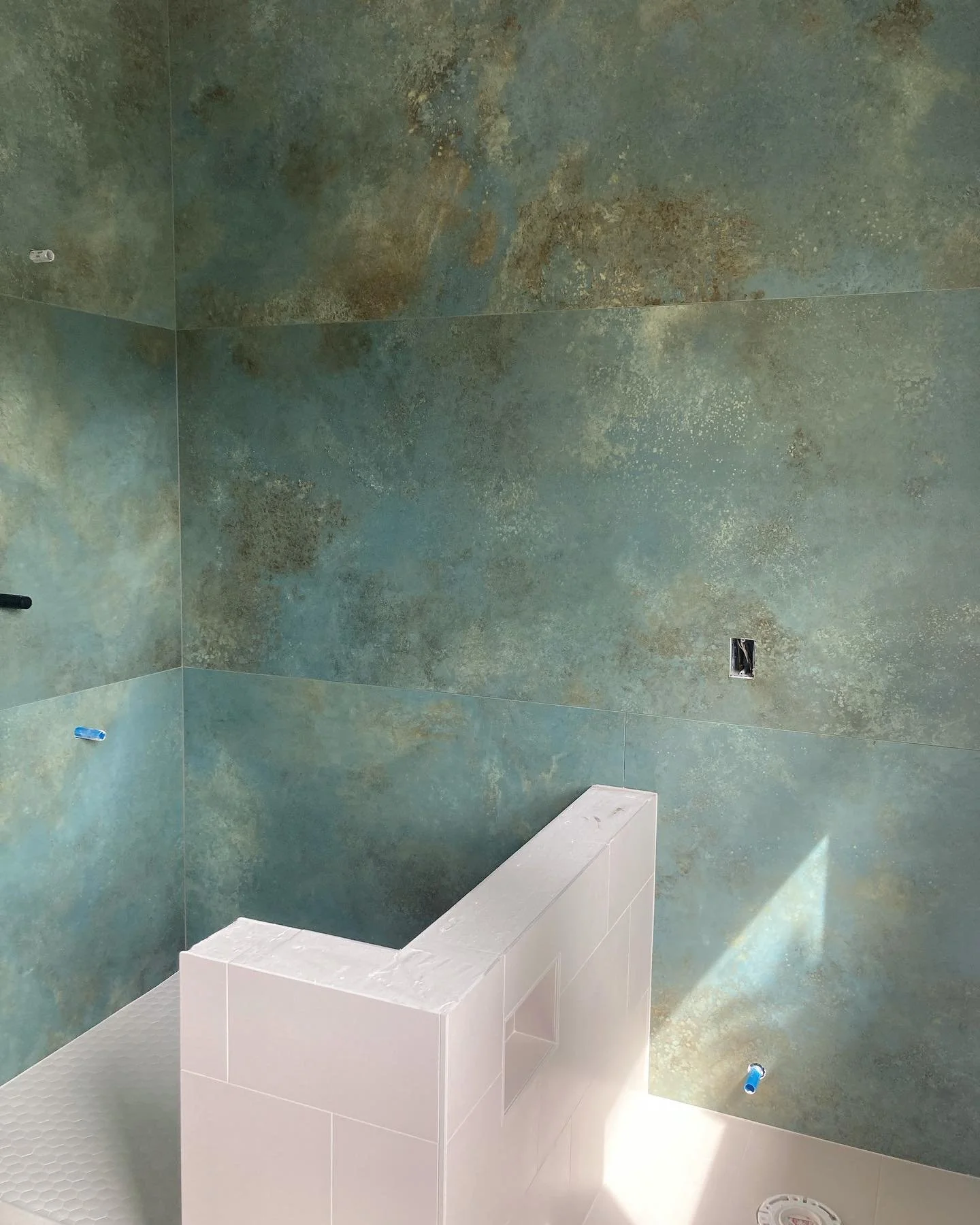 We just finished tiling this shower with 10ft porcelain slabs from Italy.  Talk about stressful!  The Rubi slab carrying system made all the difference with these.  We are waiting on the curb and wall cabs to be manufactured.