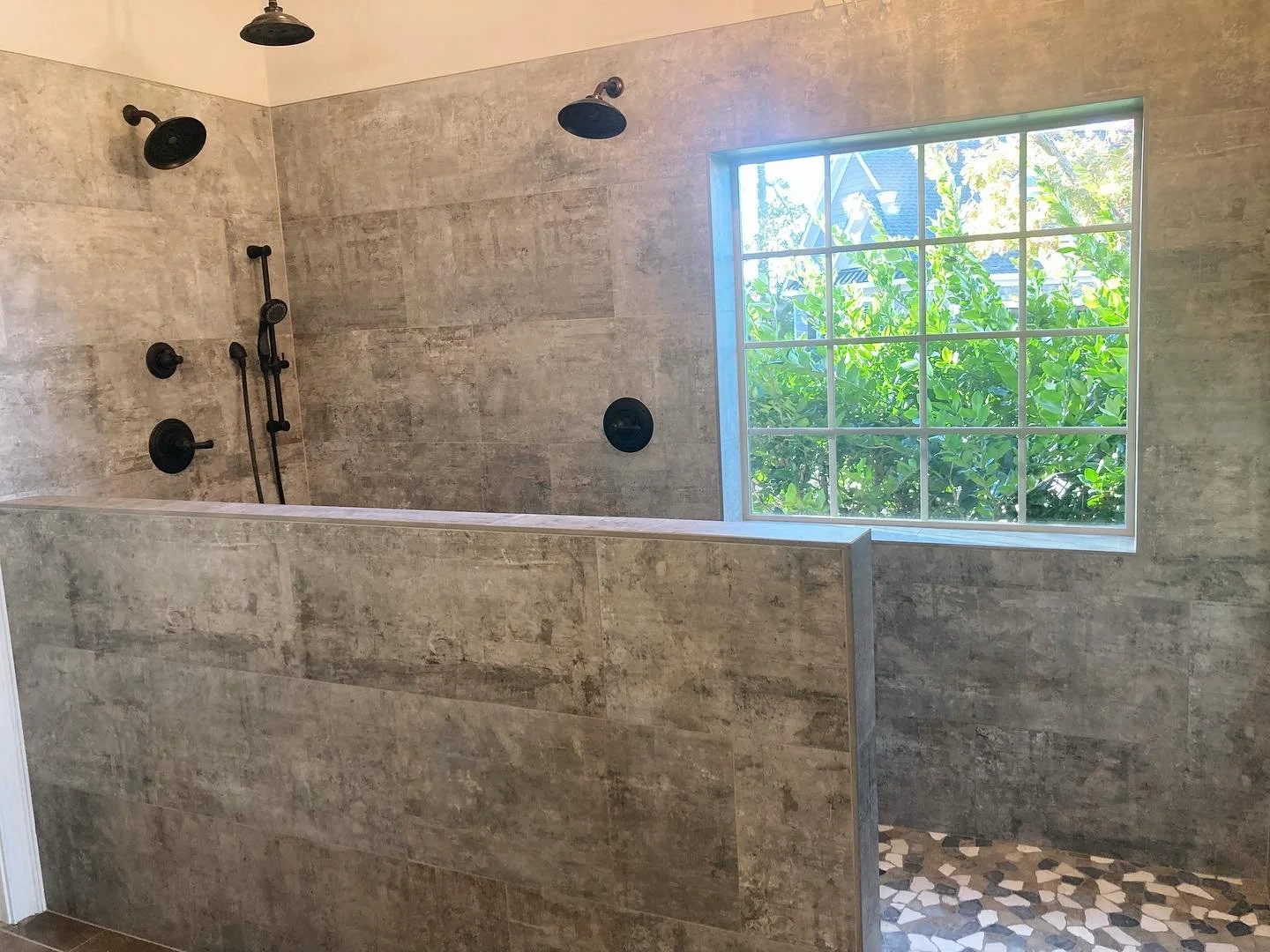 This bath had a standard corner shower with a tub under the window. We took out the tub and made a walk in shower. There will be a glass panel on the wall, but no door.