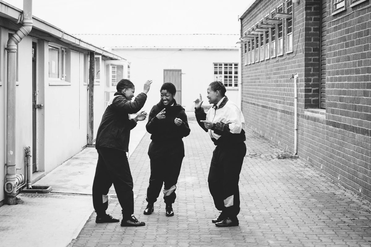 High school girls chatting together in sign language during their break.