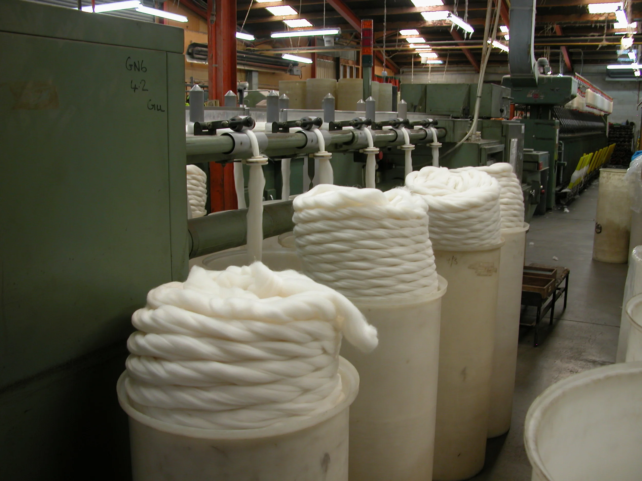 WGW being “gilled”–the process of aligning the fibres for a worsted spin. The sliver is pulled through the gilling machine many, many times to achieve the smooth, buttery feel of WGW yarn.