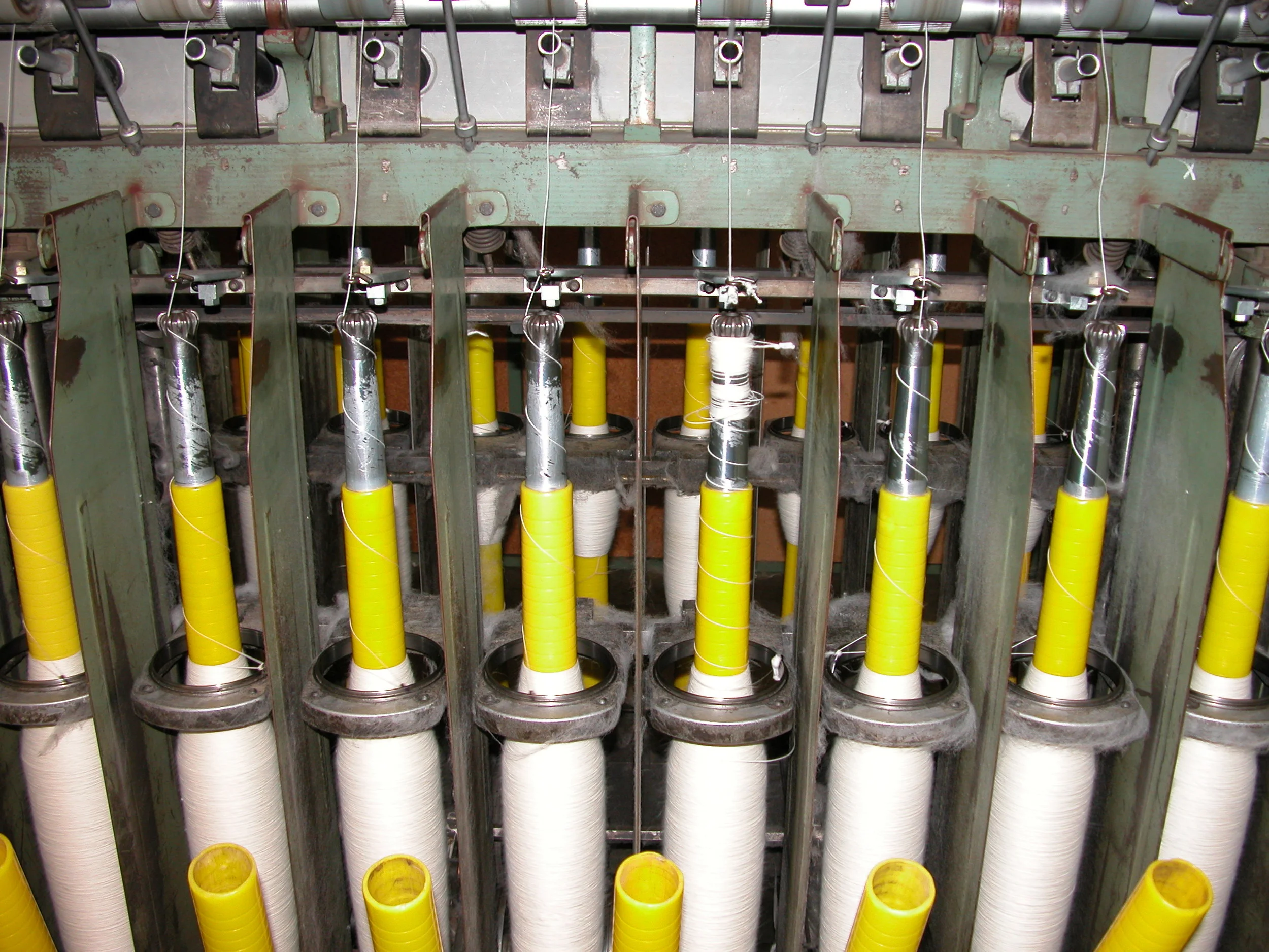 WGW on the spinning frame. Roving of about 1 cm diameter is drawn through the spinning gate to make the single strand that is later twisted (plied), combining 2 singles to get 4-ply, or 4 singles for 8 ply.