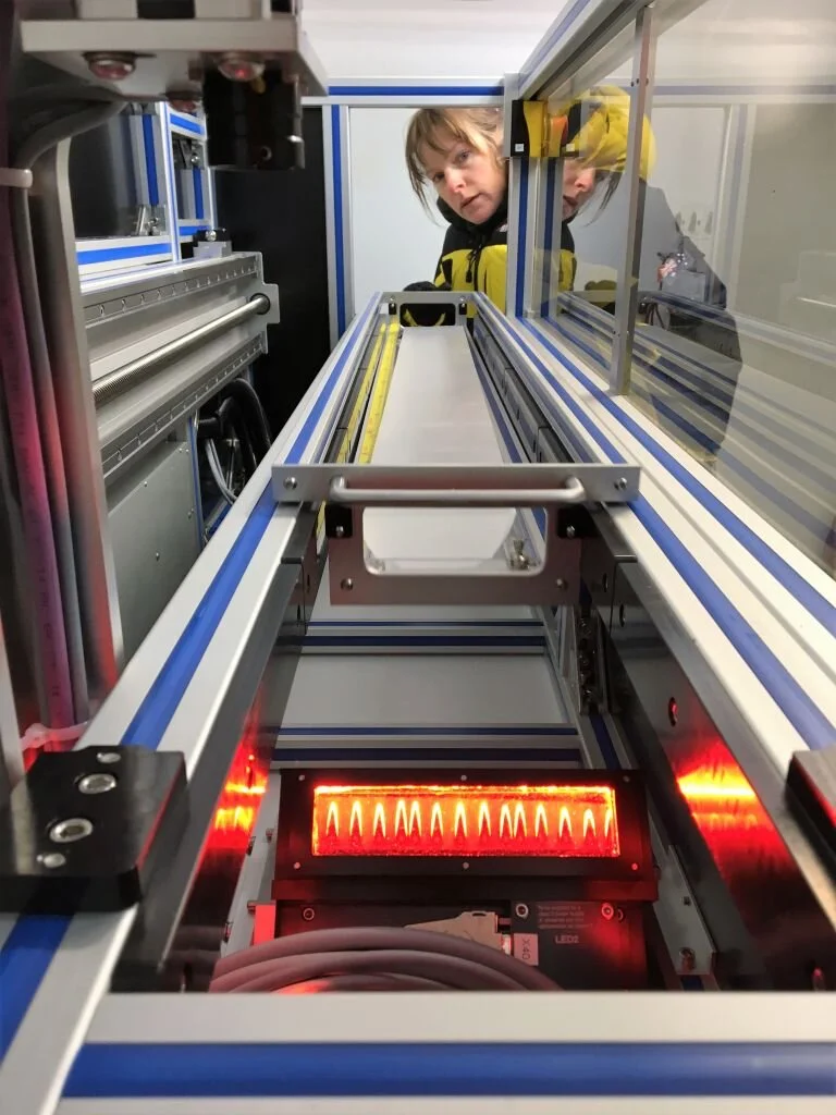 Australian Antarctic Division glaciologist, Dr Tessa Vance, examines an Antarctic ice core.