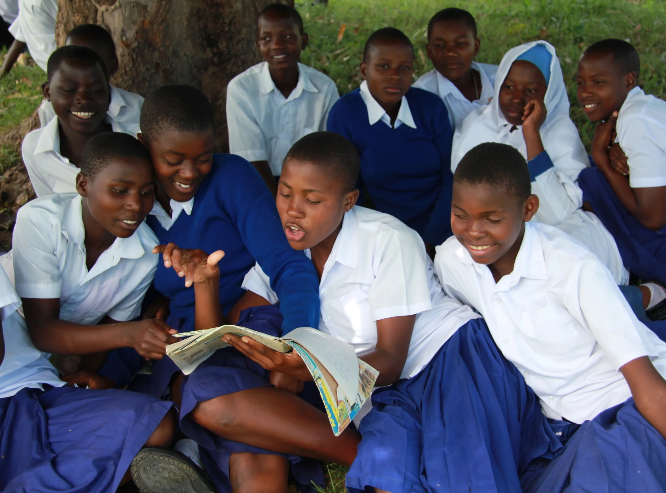 Milembe girls on grass.JPG