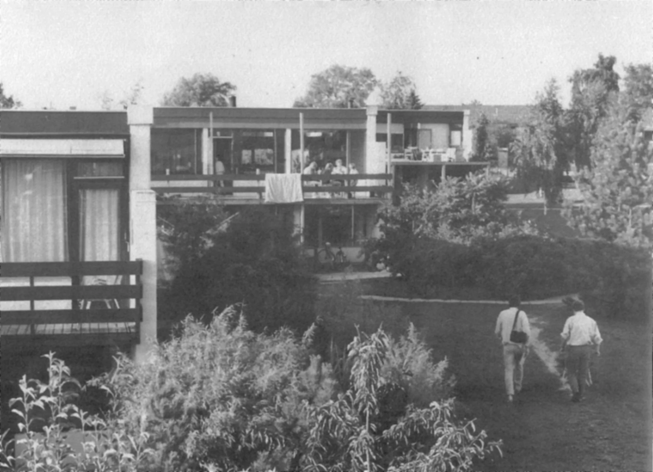 Jan and Charles Durrett walk through Skraplanet, one of the first cohousing communities built by Jan in Denmark.