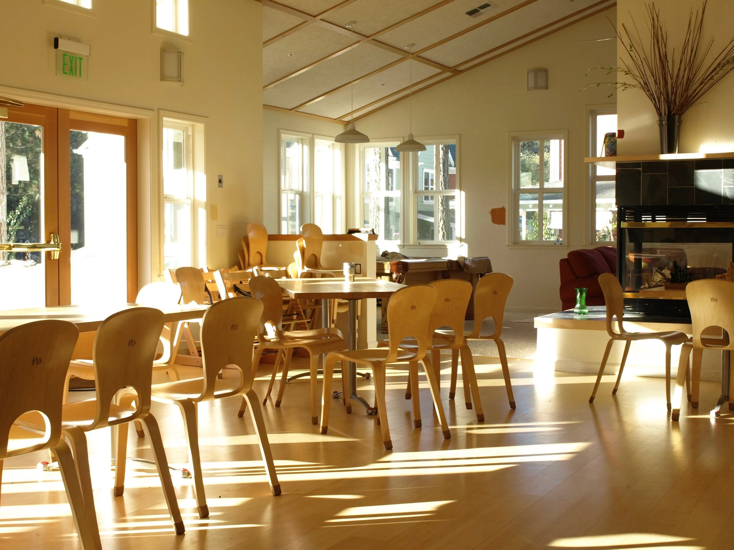 Indirect lighting, efficient insulation, high ceilings, and an open floor plan contribute to passive cooling in the Common House.