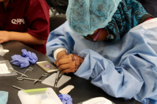 A participant learns a medical technique at Scrubs Camp