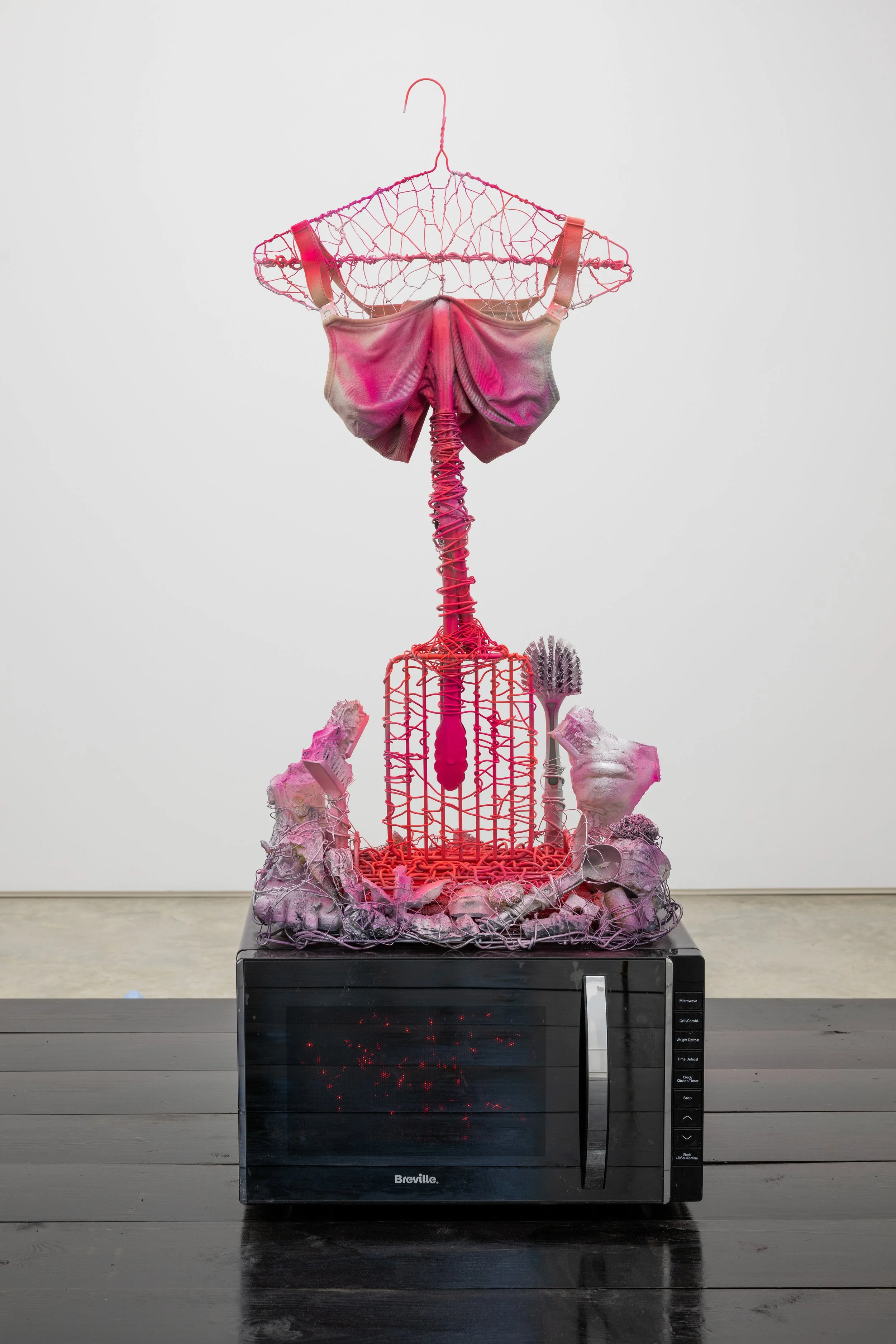   Touched a Nerve   Rosie Reed  Household objects, LED lights, plaster, paint, wire &amp; nursing bra  38 x 34 x 124cm   2026 