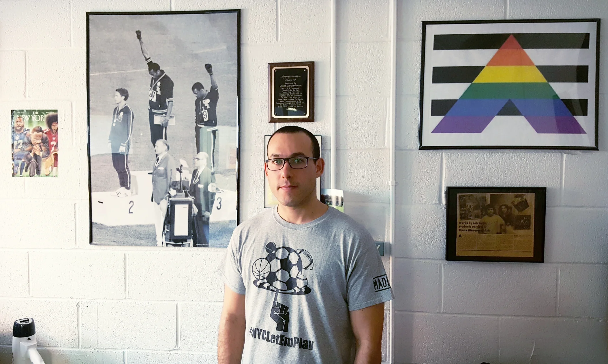 Among Mr. Garcia-Rosen's inspirations: Tommie Smith and John Carlos, black sprinters who staged a "black fist" protest at the 1968 Olympics in Mexico; former San Francisco 49ers quarterback and racial justice activist Colin Kaepernick; and Martin Luther King, Jr. With the support of his students, he founded the NYC Let 'Em Play movement to raise awareness of sports inequity in New York City high schools. Pictured here in his dean's office at Bronx Academy of Letters