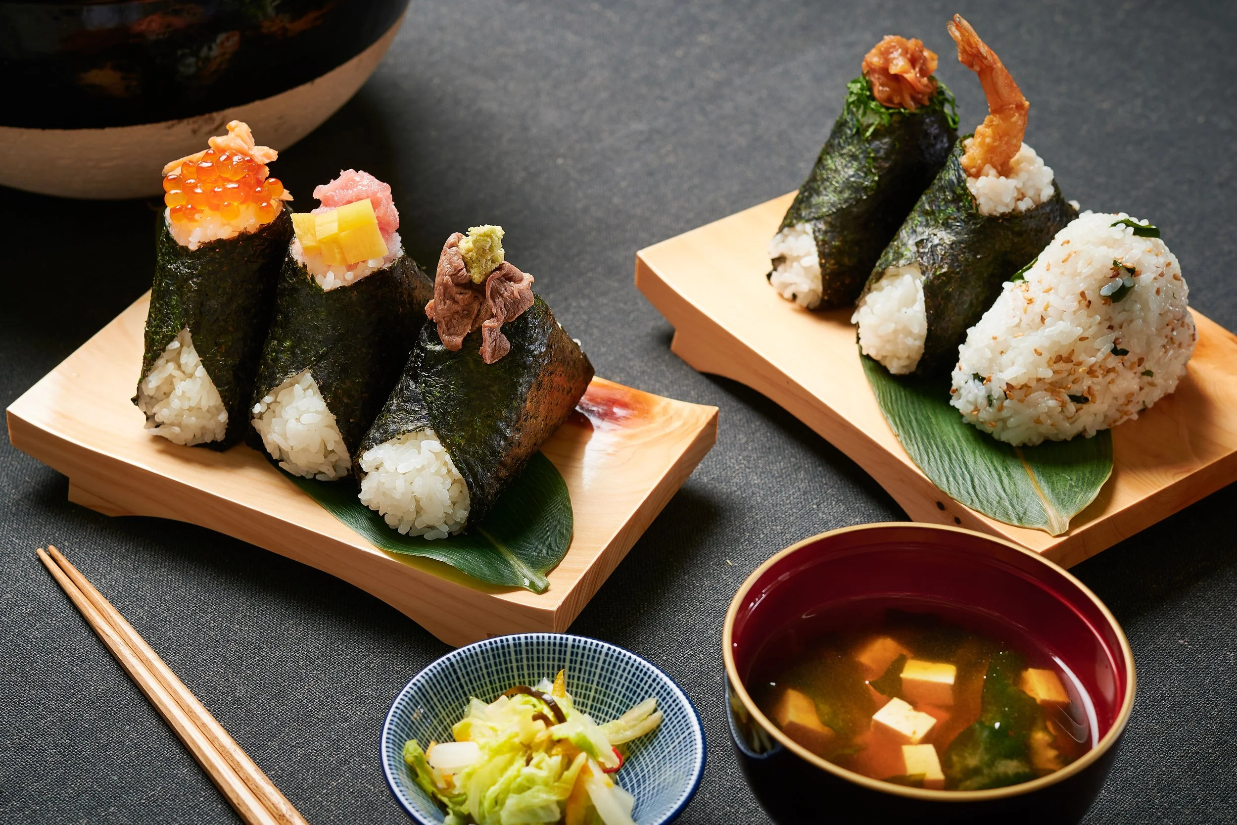 Assorted onigiri on wooden plates