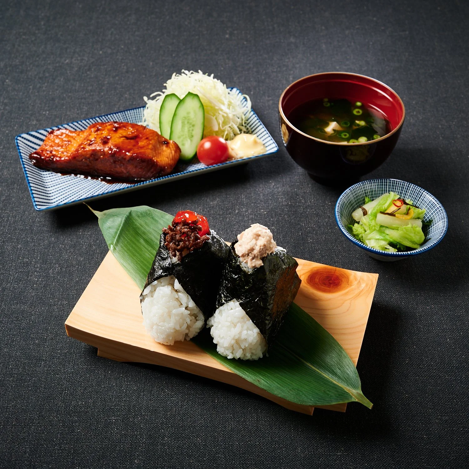 Onigiri combo with two onigiri, teriyaki salmon, pickled vegetables, and miso soup