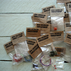 Amelia Marzec, New American Sweatshop Products, 2013-14, Re-purposed materials including paper, plastic and electronics, 2 x 3.5 x .5 inches each