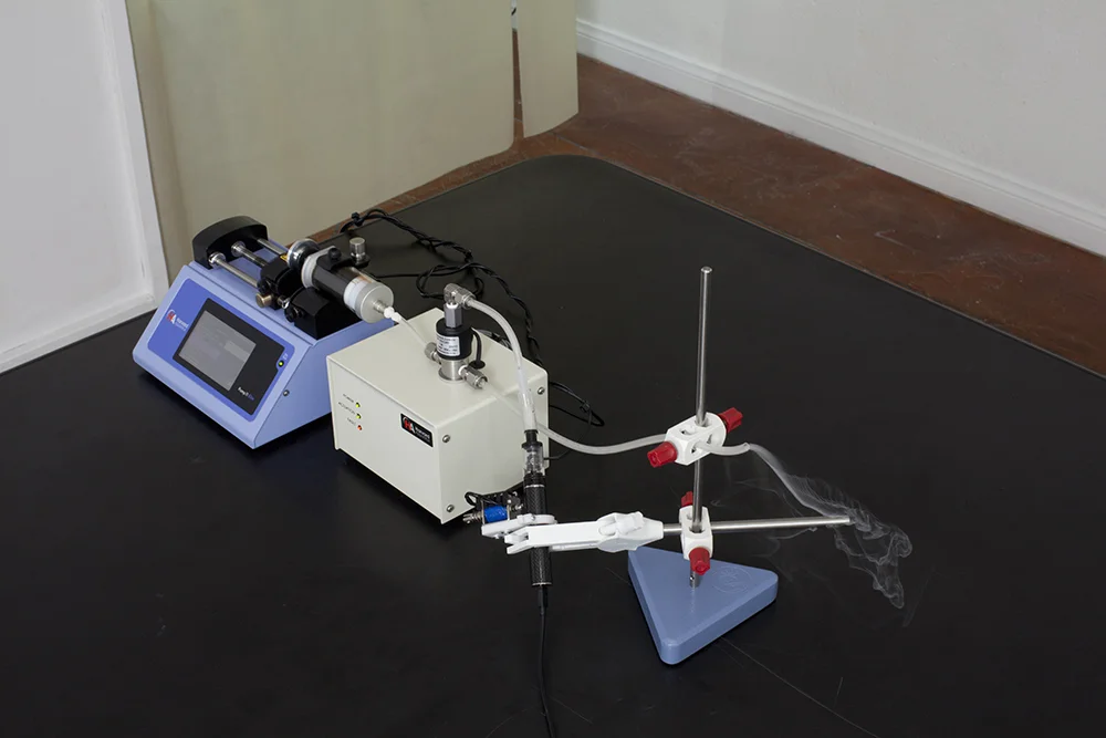 Vapebot, no. Linqox Criss (2018), Infuse/Withdraw Medical Syringe Pump 11 Elite, glass syringe, valve box, Aspire K3 vape pen, custom vape e-liquid whose formula is based upon hypothetical HTML body metrics of the Second Life avatar Linqox Criss