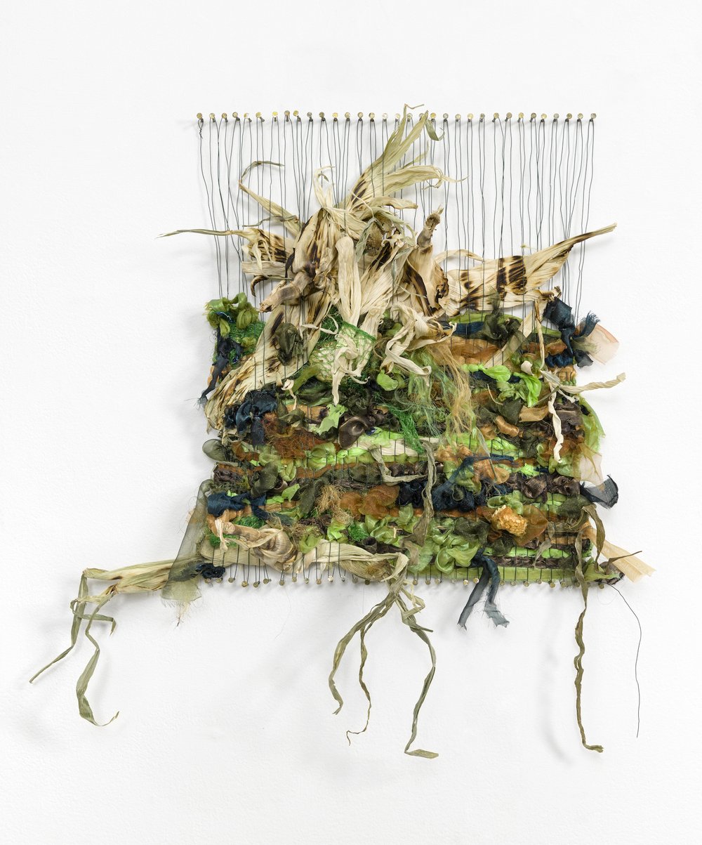  Zoila Andrea Coc-Chang,  más mazorca verde , 2021, Silk organza, corn husks, corn, plastic, glitter, floral wire and nails on wall, 26 x 24 x 4 inches. Photo: Etienne Frossard. 