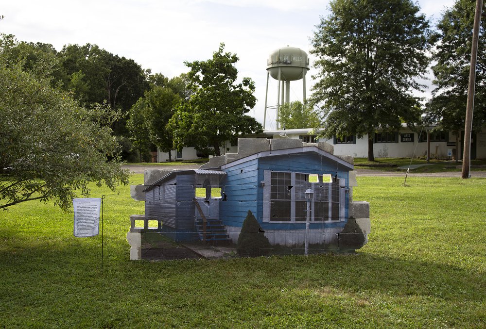  Amy Ritter,  83 Goethals Community , 2021, Color photographic Xerox print, cinder blocks, garden flag, 64 x 120 x 8 inches. 