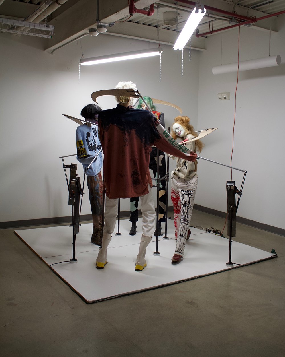  Anoushé Shojae-Chaghorvand,  If anyone is going to kill my friends, it’s going to be me , 2019, Silicone, synthetic/ horse/ artist’s hair, tattoo ink, steel, motors, plywood, found clothing, 96 x 96 inches.   
