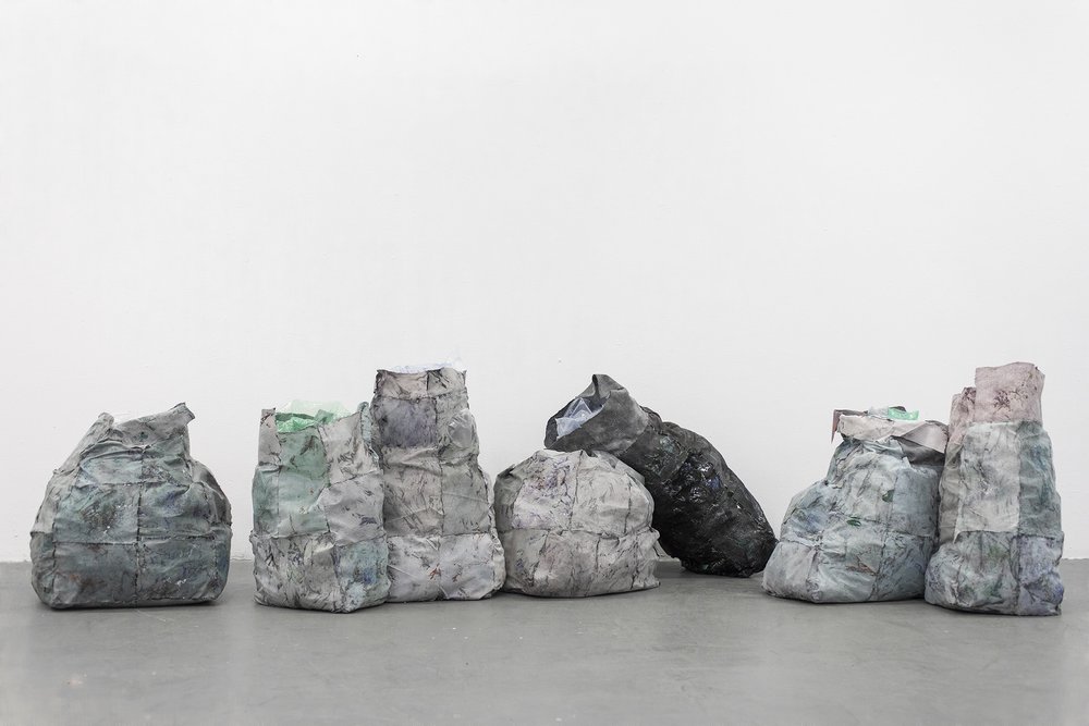  Xinyi Liu,  Sacrifice , 2022, disposable washcloth, acrylic, packaging bubble, trash bag, staple, 130 x 30 x 40 inches 