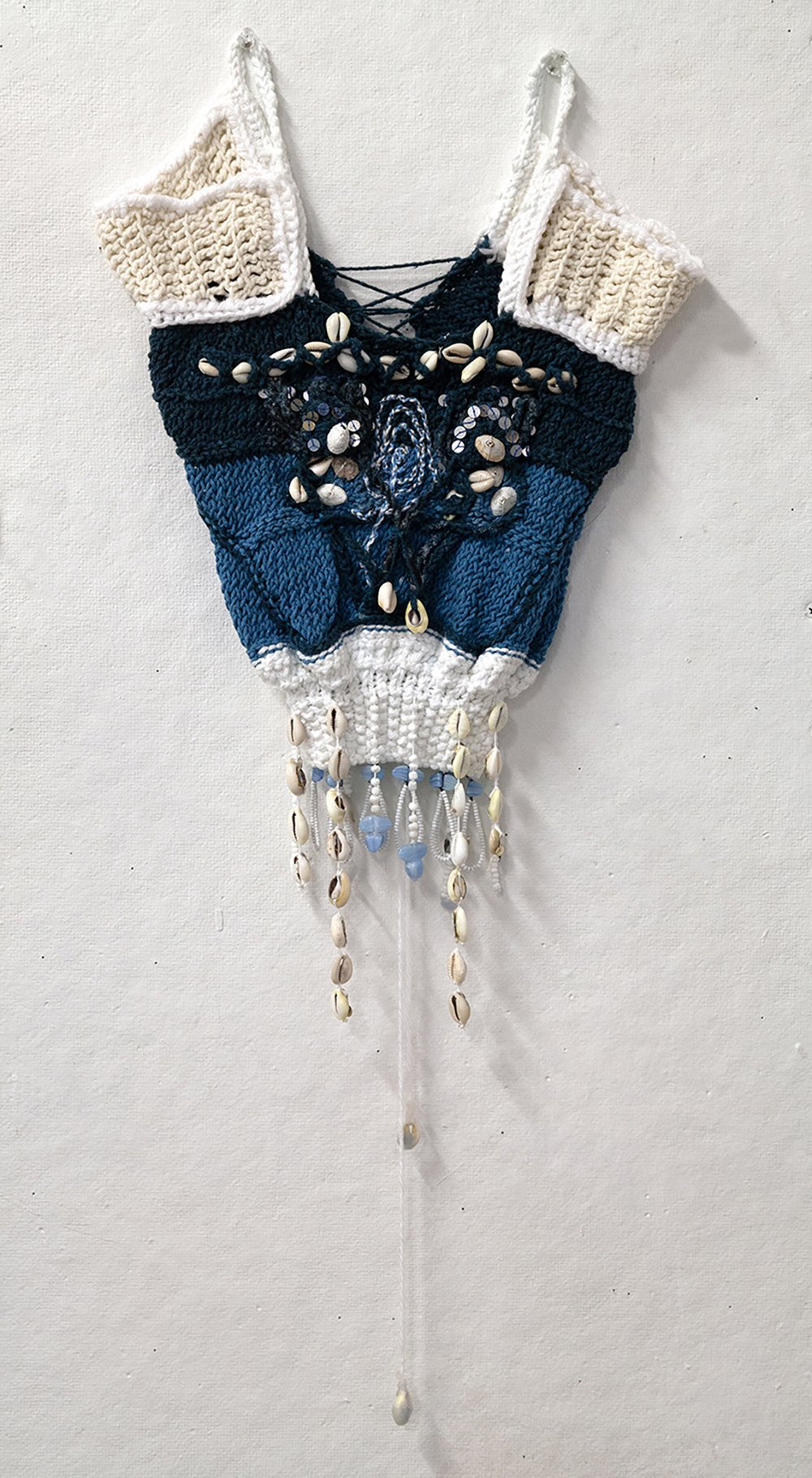  María de Los Angeles Rodríguez Jiménez,  mask i , 2022, Cotton, seashells, sequins, and wax, 14 x 10 inches. 