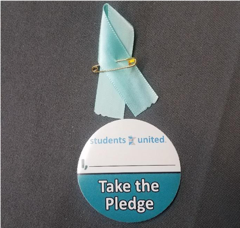 The pledge and teal ribbon during the tabling session