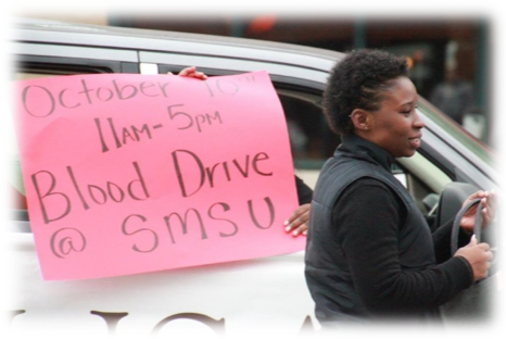Action Team member, Jackye Meba, walking in the SMSU Homecoming parade
