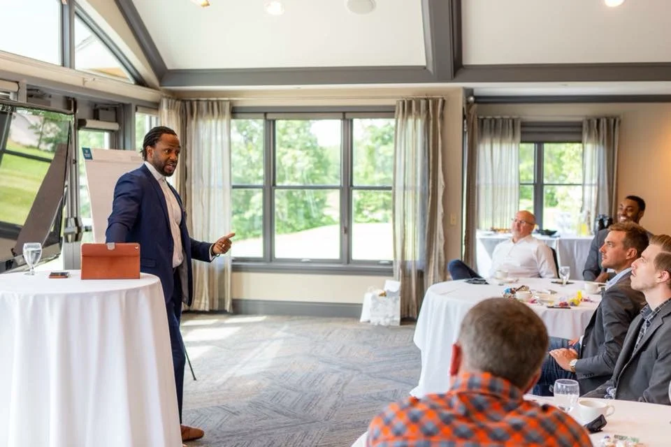 Executive and business coach Attah Obande leading a leadership working session with a group of leaders