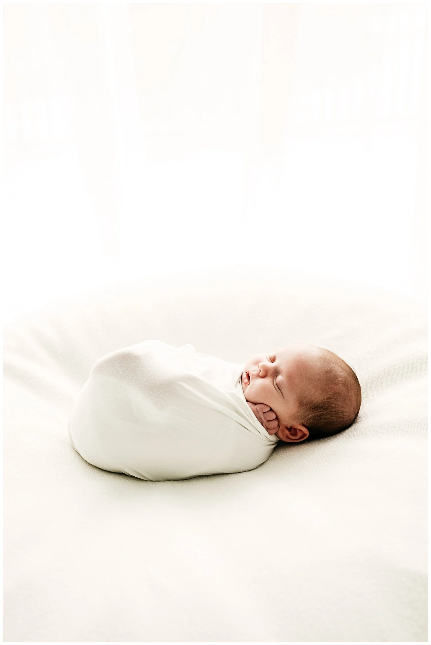 A photo depicting a sleepy baby in a dream-like landscape.
