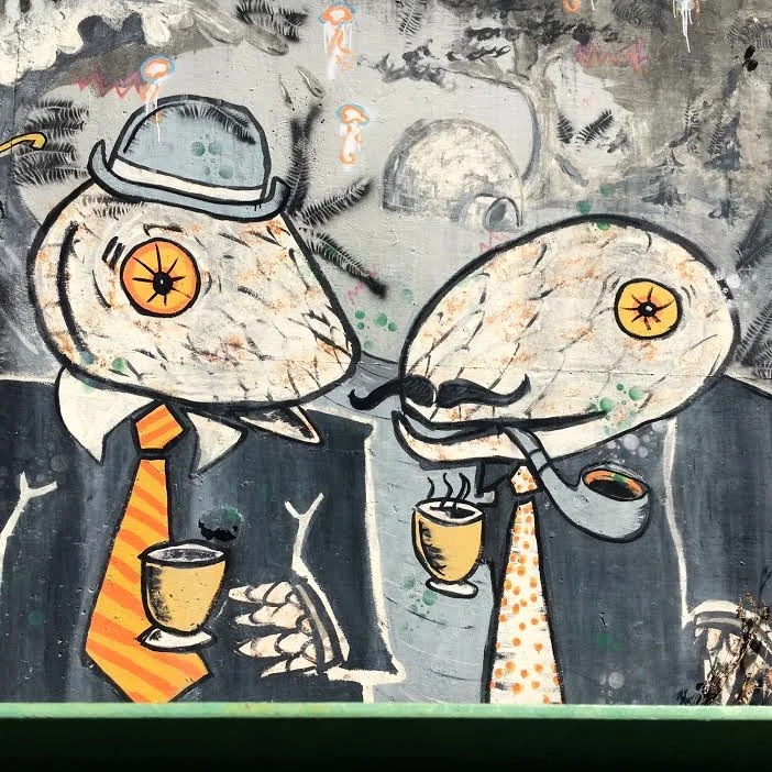 Two odd fellows adorn the concrete support of a suspension bridge spanning the Salmon River 