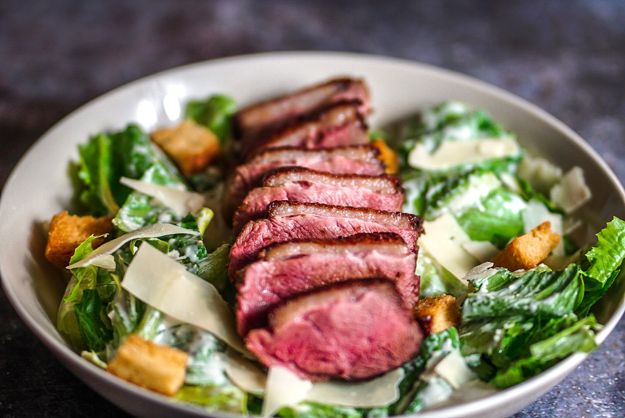 Peppered Duck Caesar Salad Homemade Roasted Garlic Croutons and Shaved Parmesan