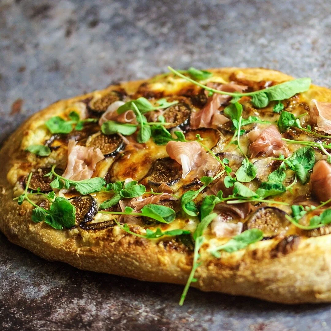 Fig & Prosciutto Pizza with Balsamic Onions Whipped Ricotta Mozzarella Parmesan and Watercress 