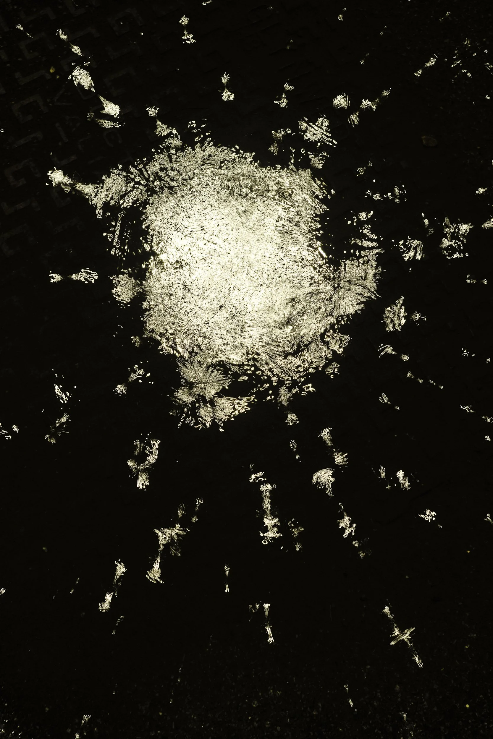 winter puddle (II) in morrisons car park, in the rain