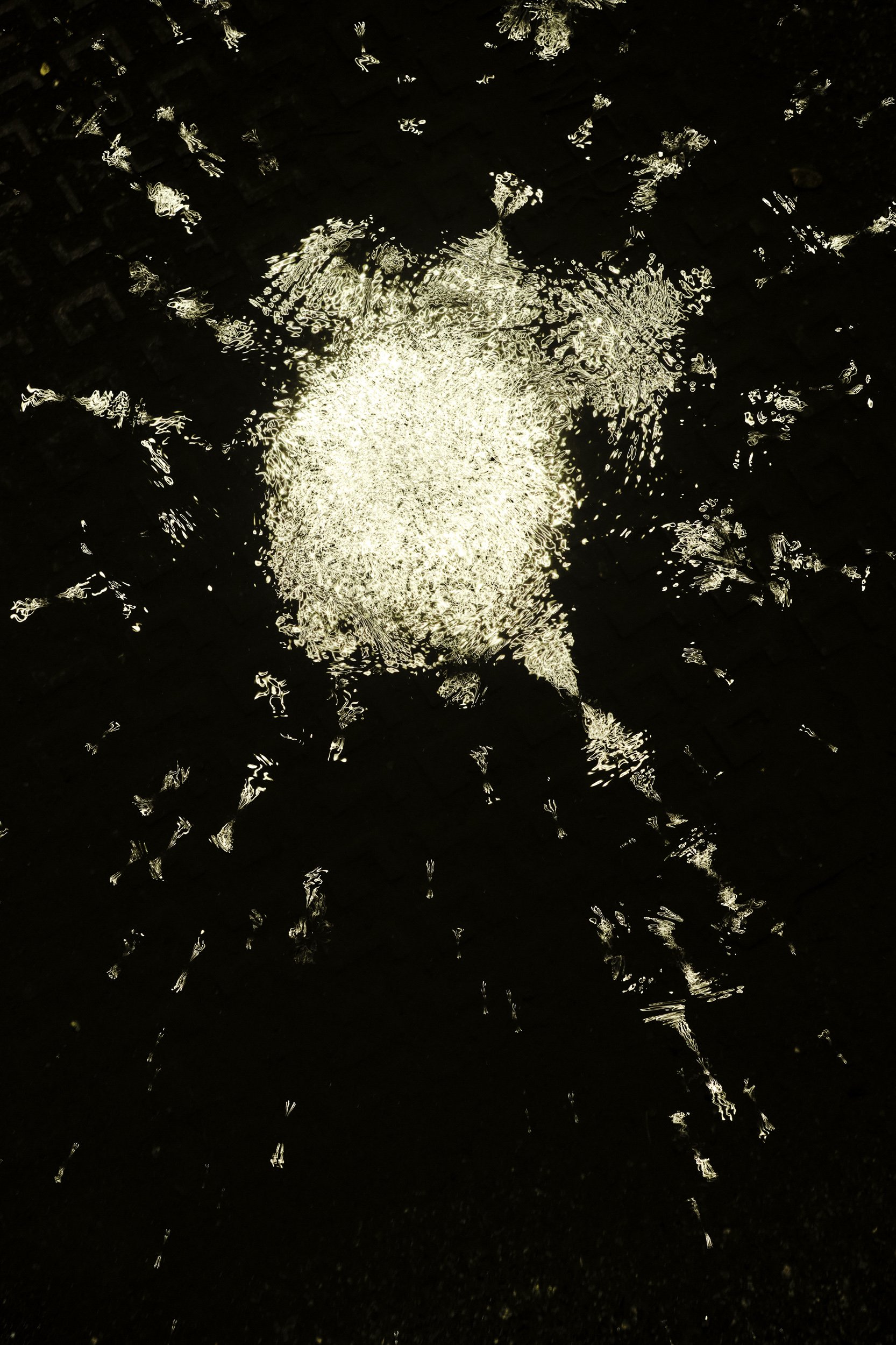 winter puddle (I) in morrisons car park, in the rain