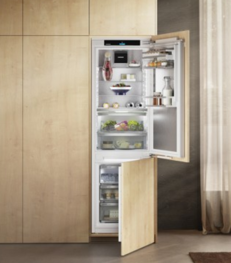 Open refrigerator with food and beverages inside, set against a wooden wall and a curtain on the right.