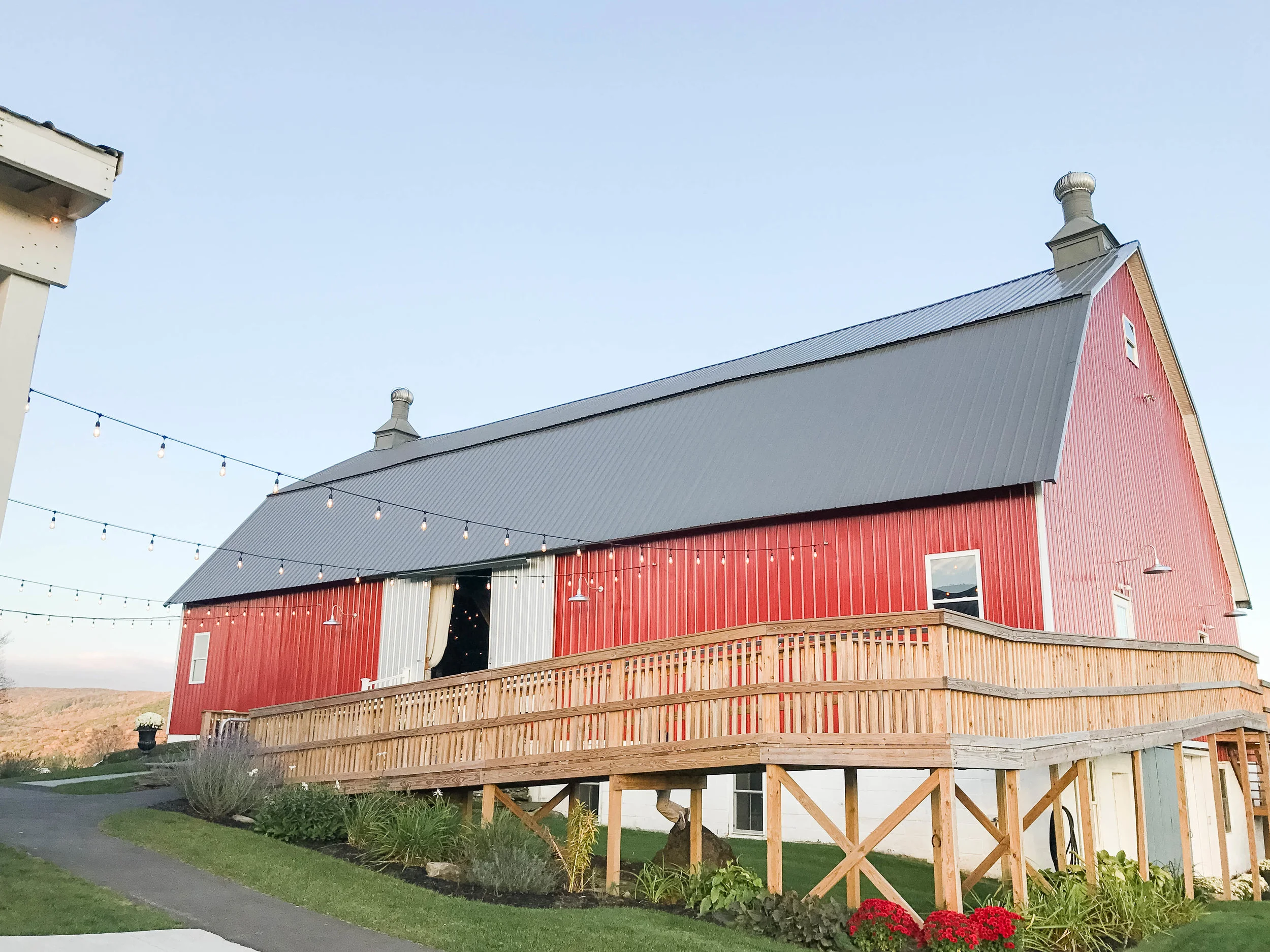 the Big Red Barn with string lights for wedding at Farm at Cottrell Lake by Elk Mountain Ski Resort