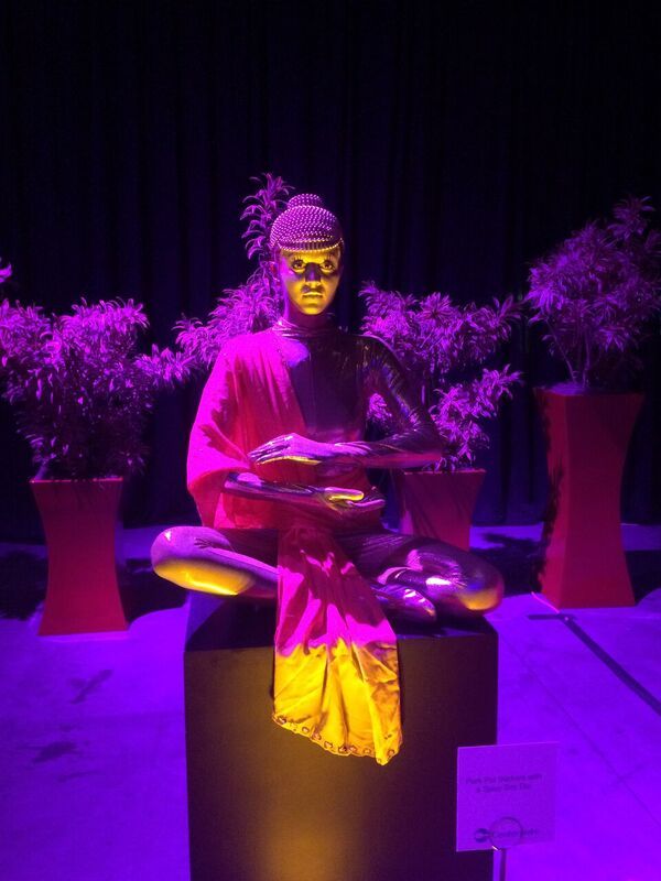 Asian statue inspired living statue in gold and red