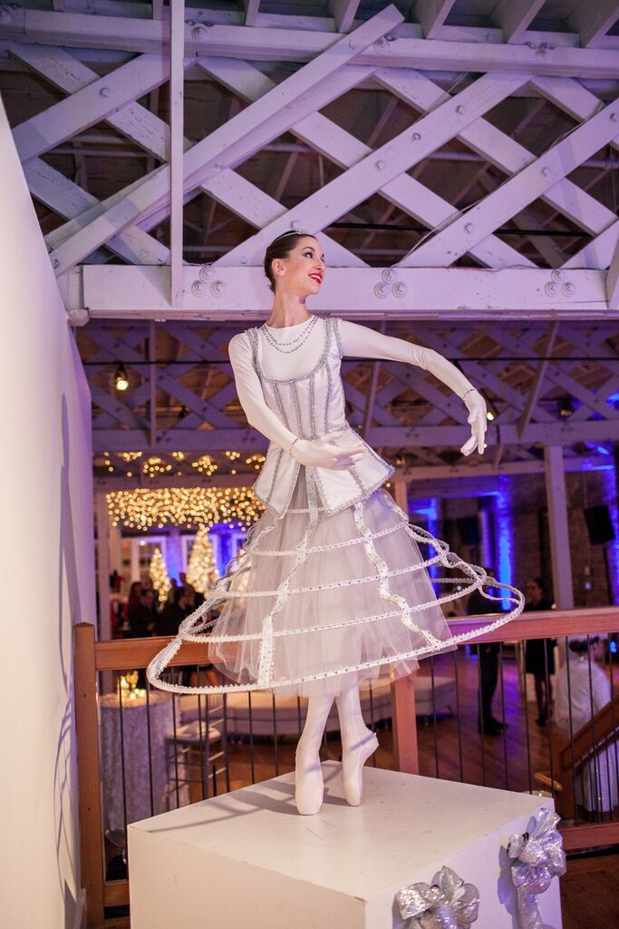 Winter Ballerina in pointe shoes and white costume with a long tulle skirt and overskirt made of hoops