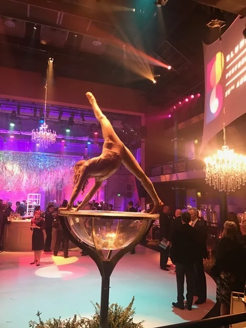 Martini Glass Performer in White Striking a Needle Pose