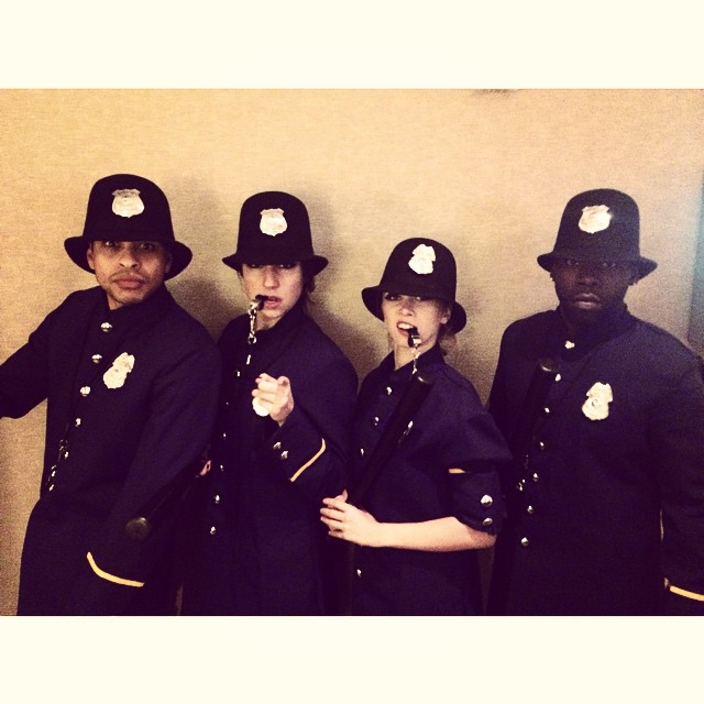 Four 1920s bobby cop performers dressed for a 1920s themed event
