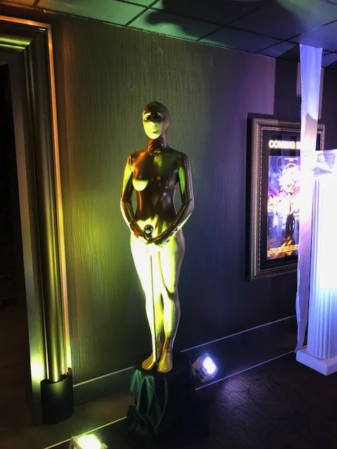 Living statue costumed to look like a golden Oscars Statue