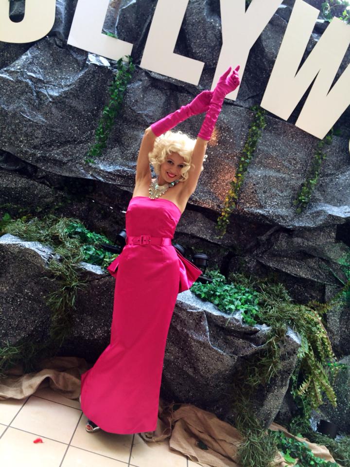 Marilyn Monroe inspired performer costumed in a pink dress for a Hollywood themed event