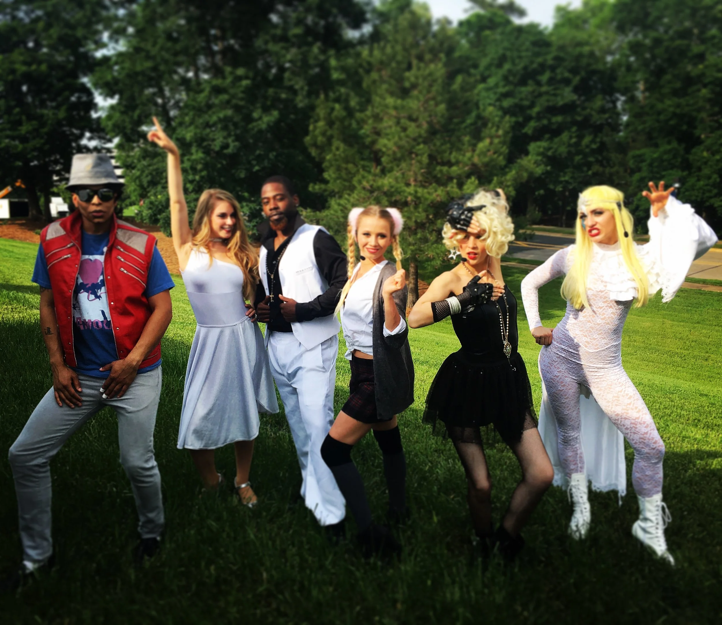 Celebrity inspired performers posing for a photo at a 90s themed event