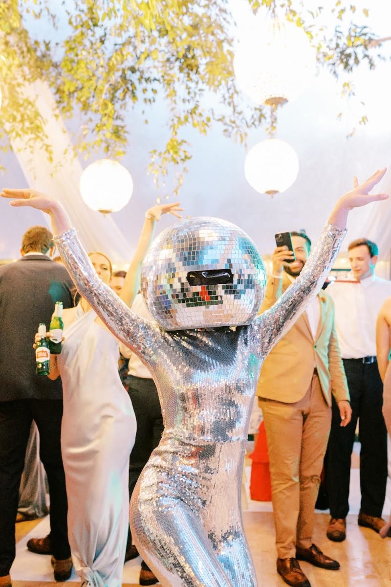 Living Disco Ball performer posing with their arms up while performing at a wedding