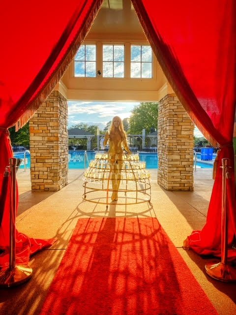 Goldfinger inspired body painted performer inside a Champagne Dress handing out drinks during a James Bond themed event